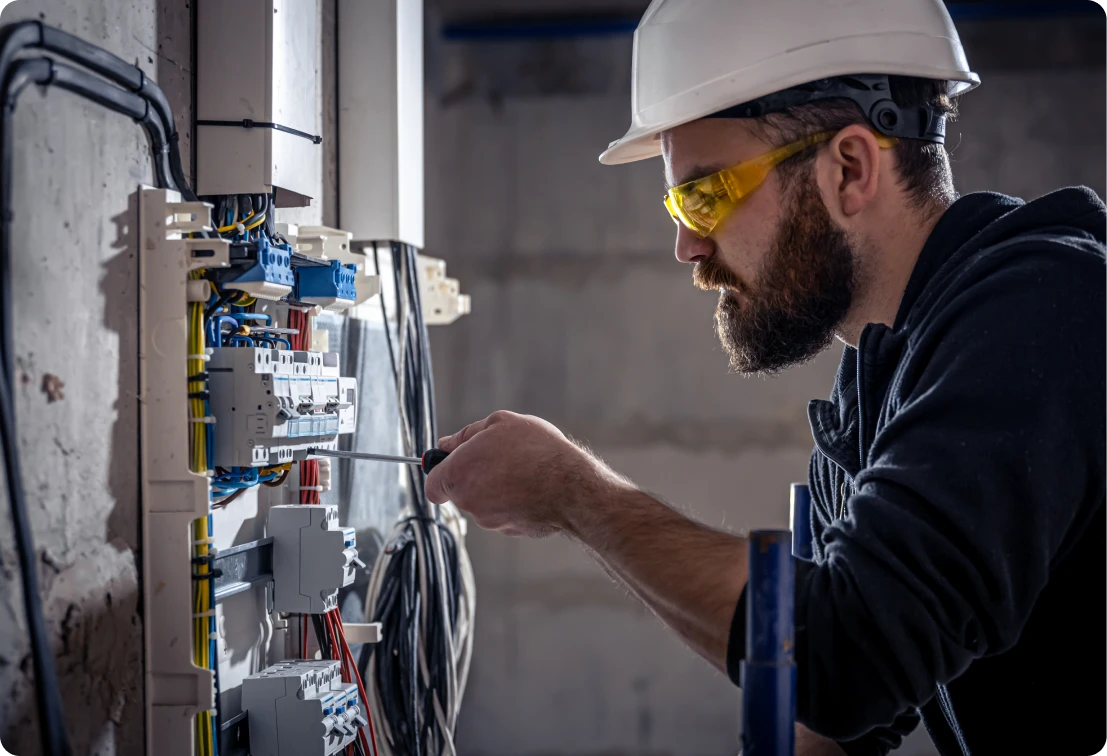 Electrician working on circuit breaker panel