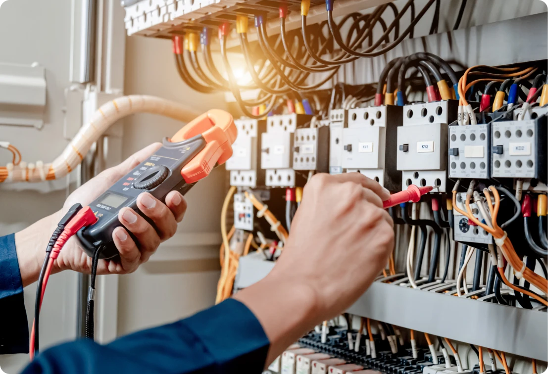 Technician working on electrical panel