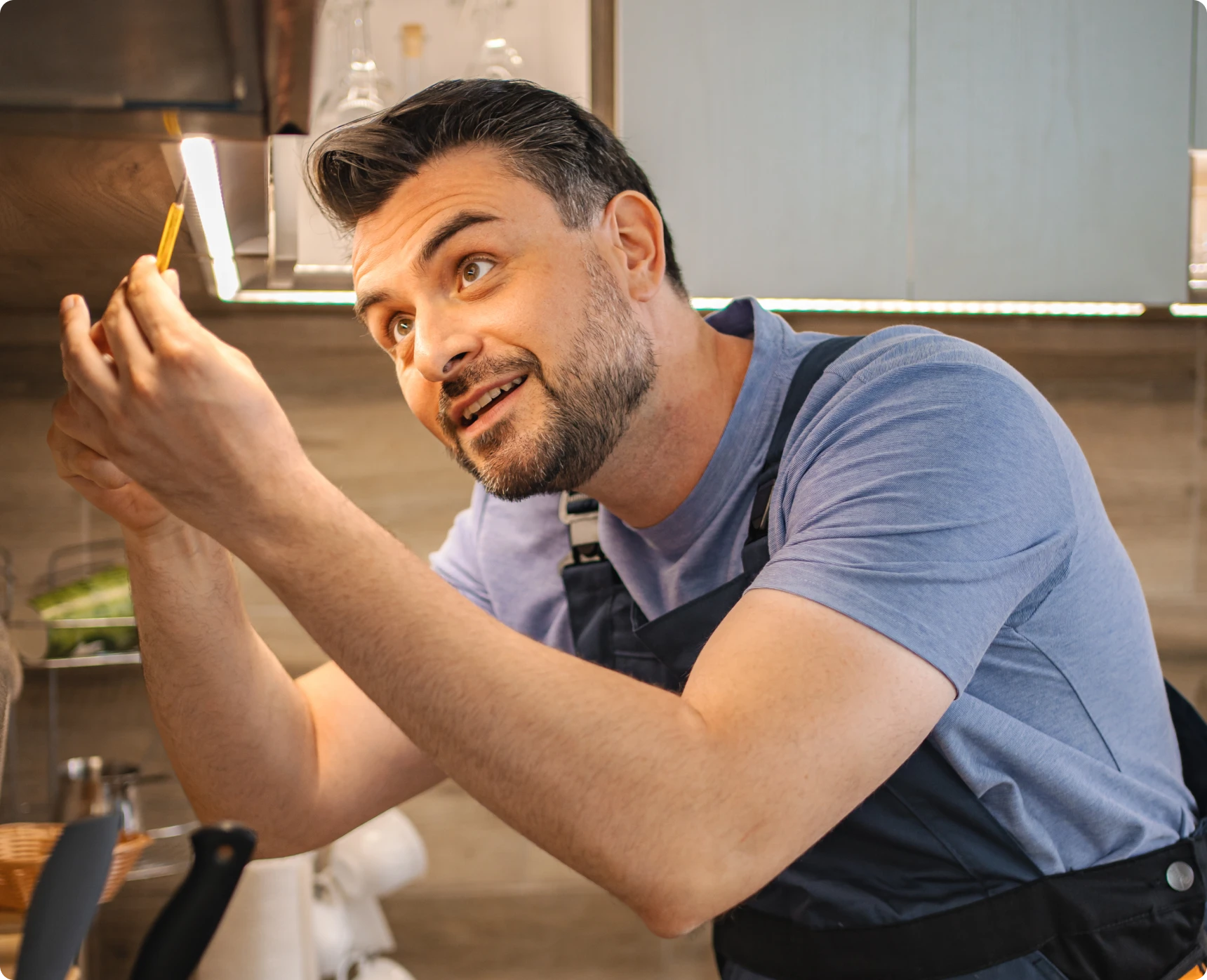 Person fixing kitchen light fixture
