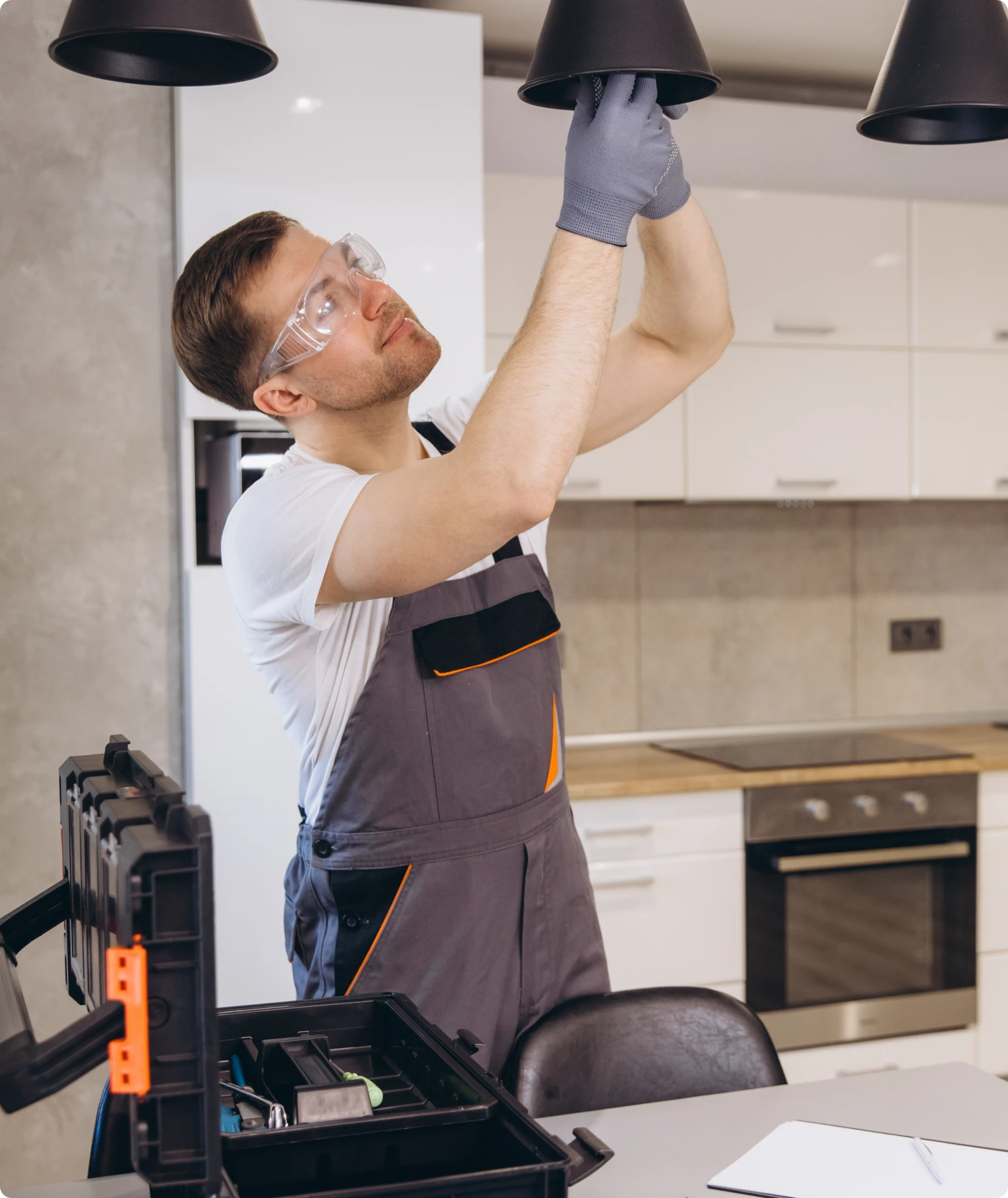 Electrician fixing kitchen light fixture