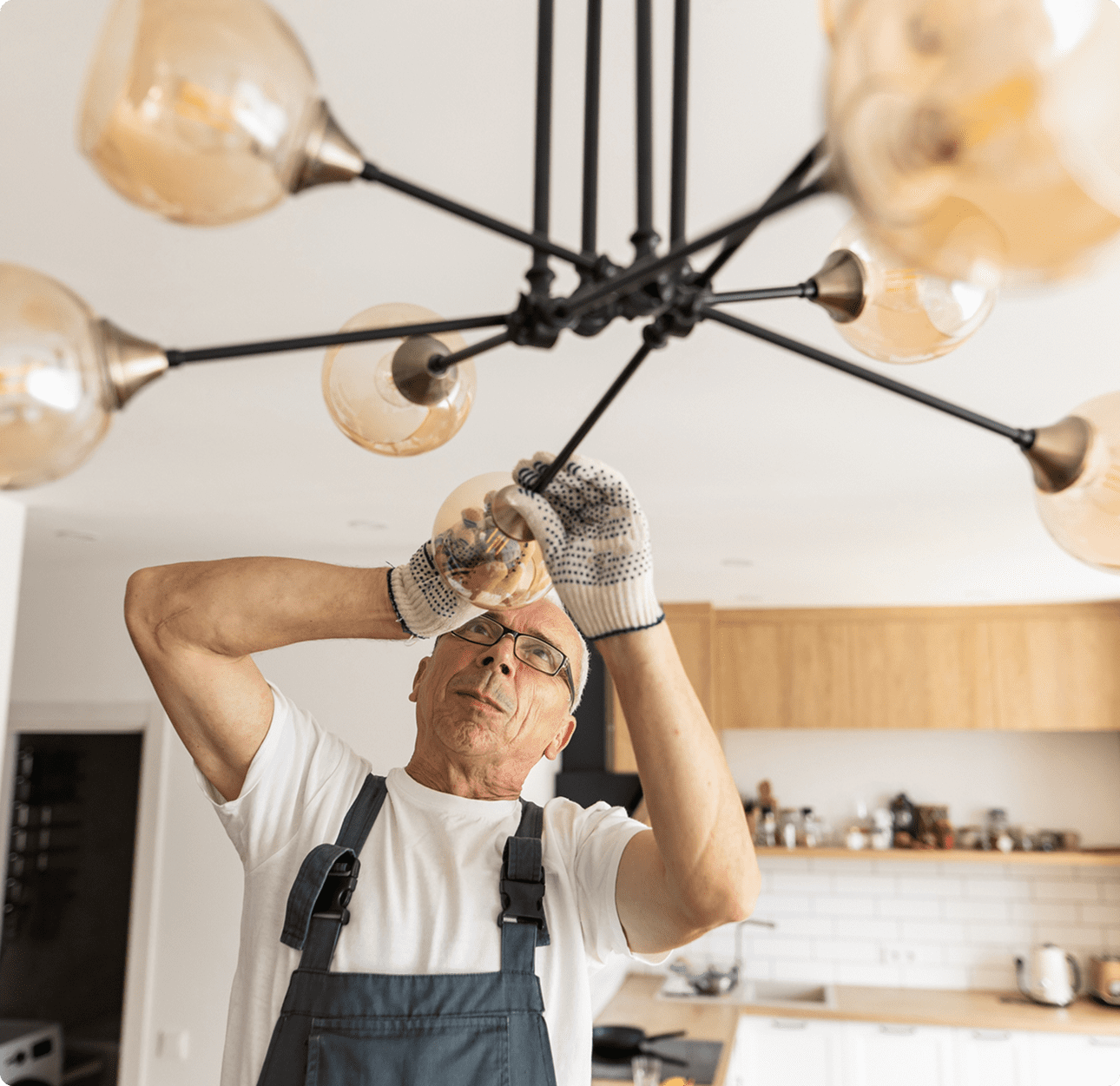 Man installing modern chandelier