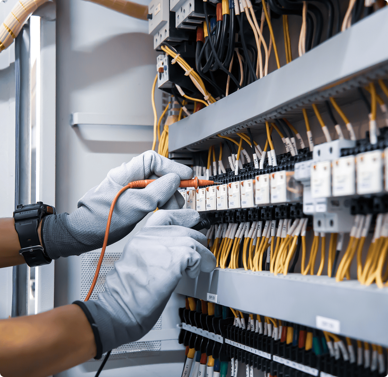 Hands adjusting electrical components in panel