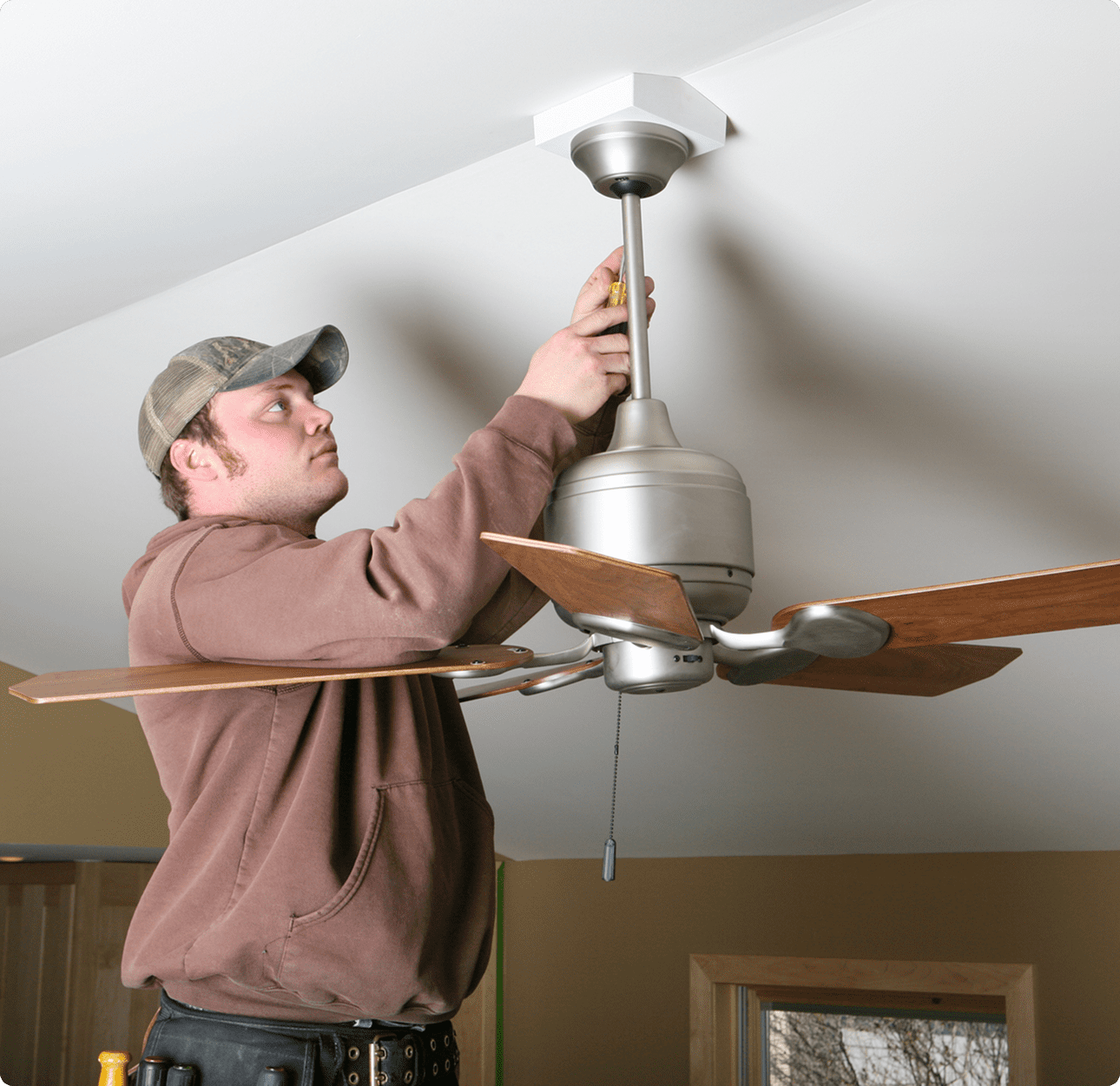 Man installing a ceiling fan