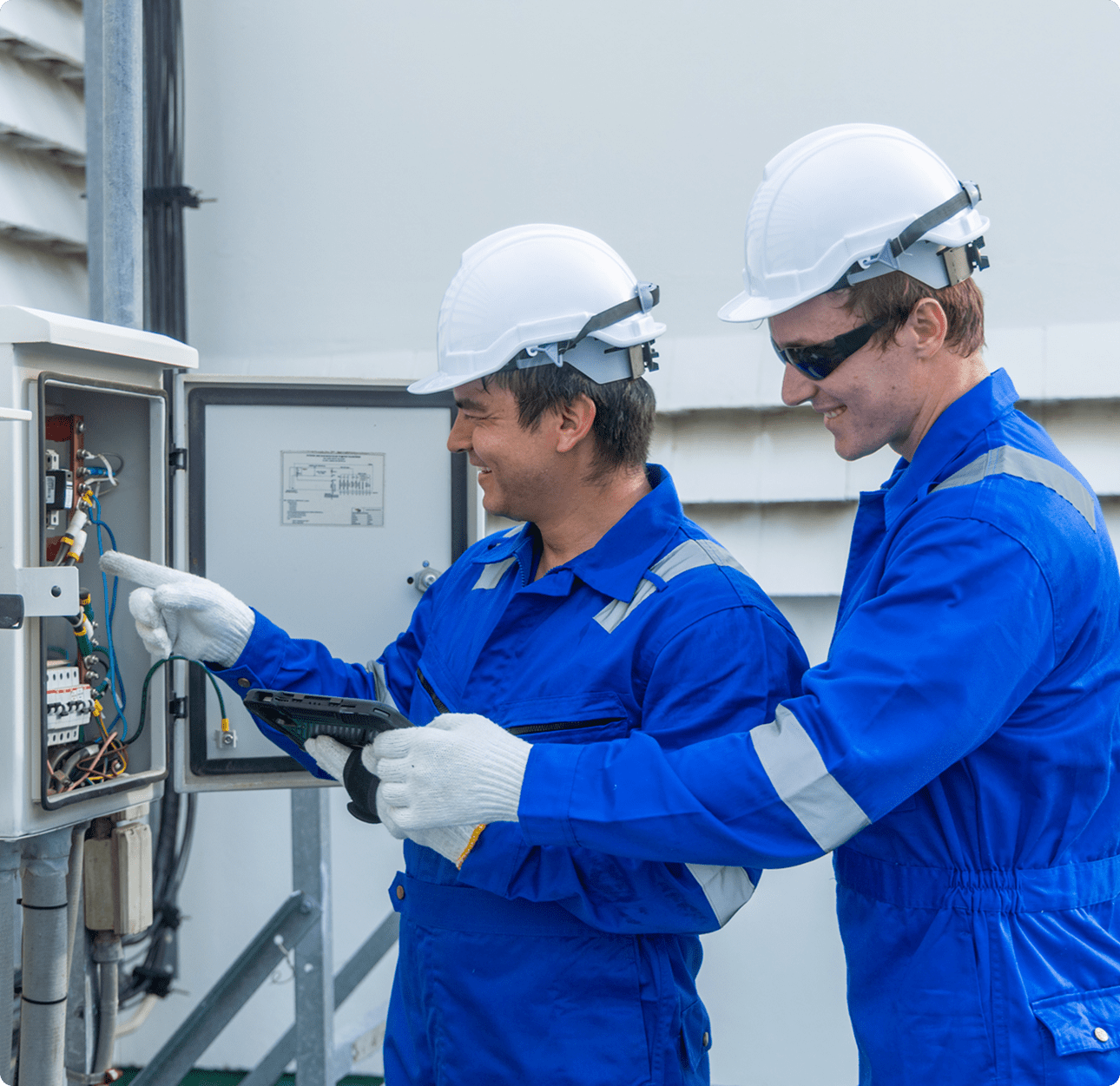Engineers working on electrical panel outdoors