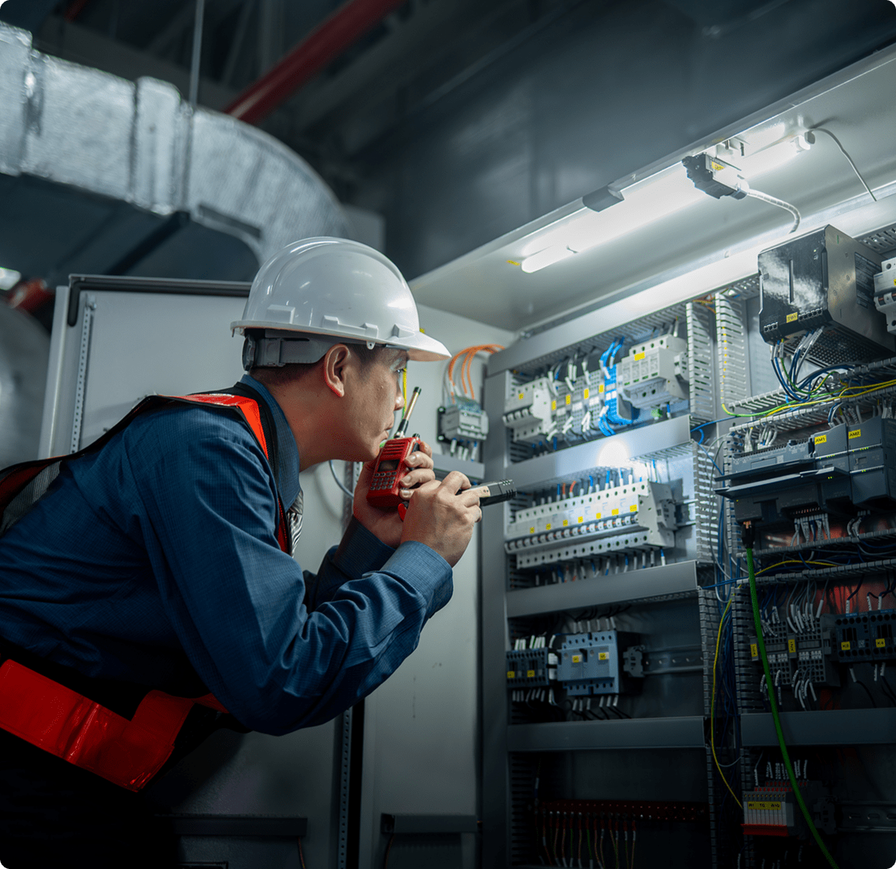 Worker in hard hat checking electrical system