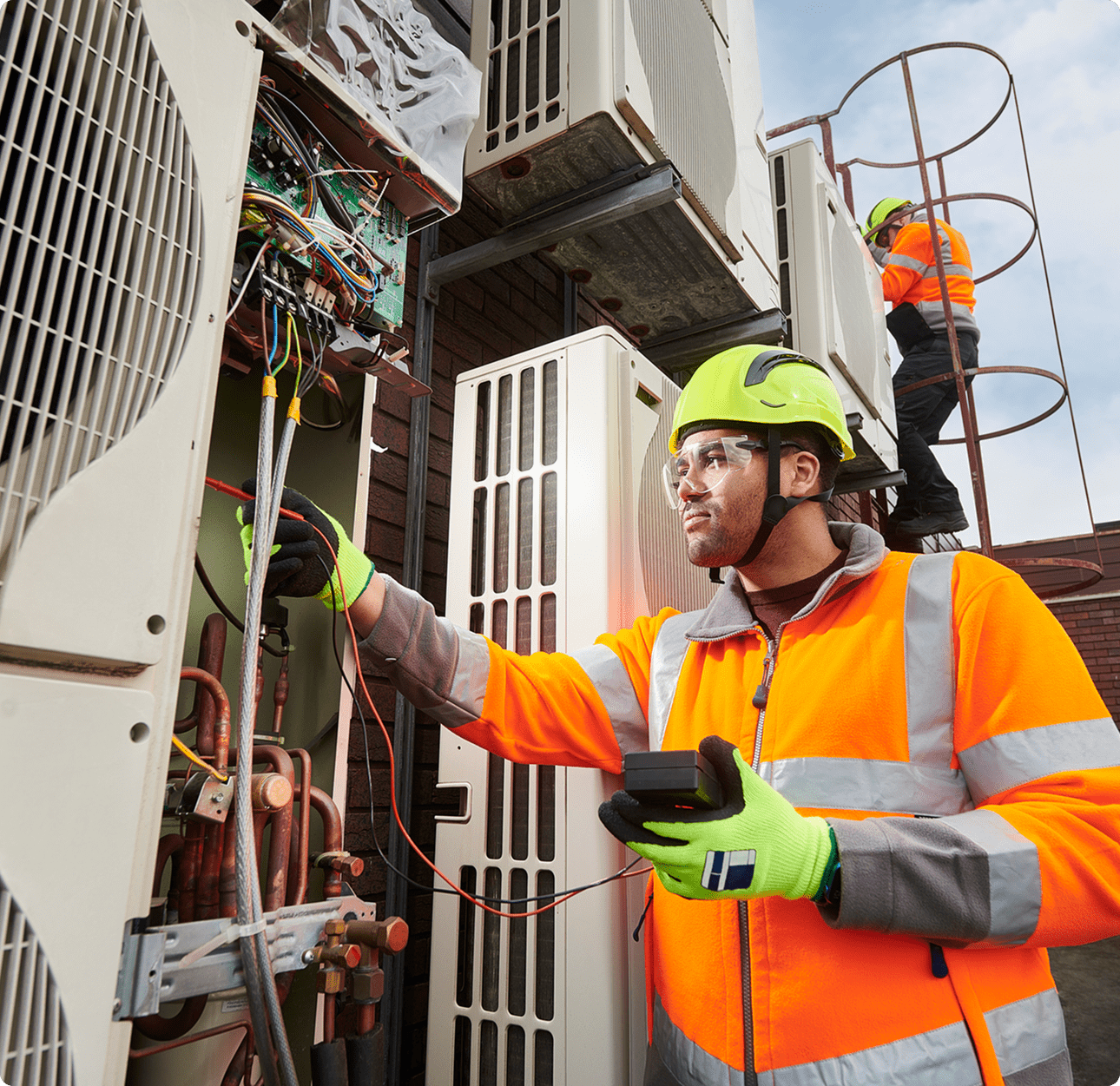 Engineer maintaining air conditioning equipment