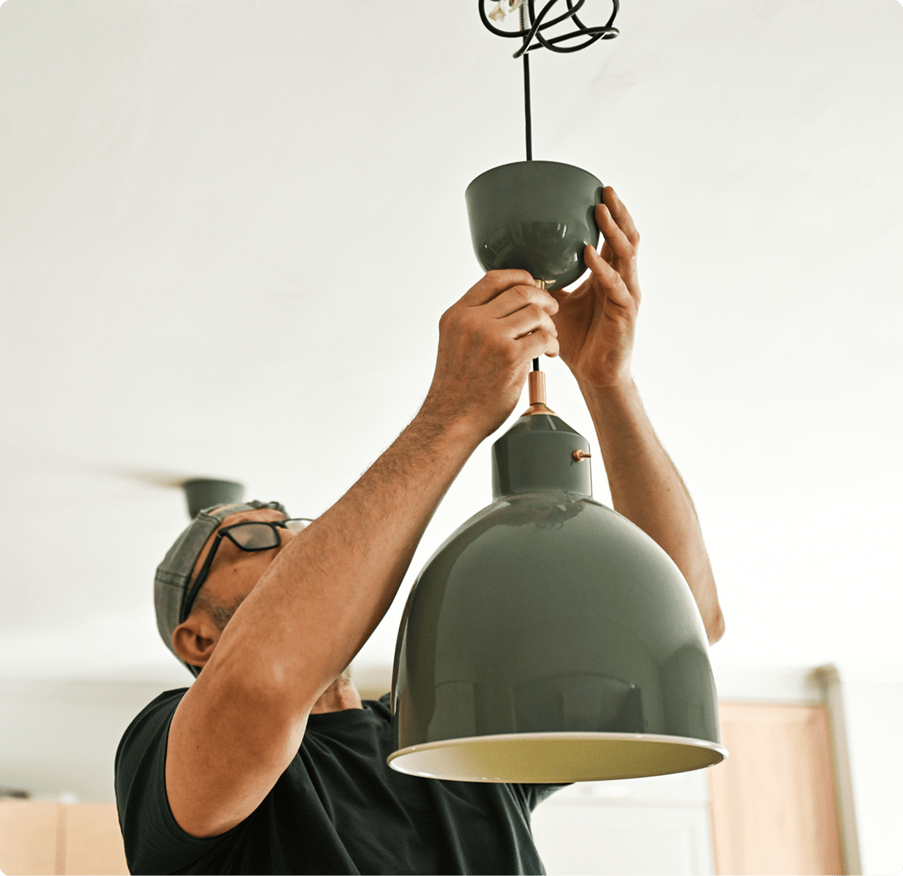 Man adjusting pendant lamp