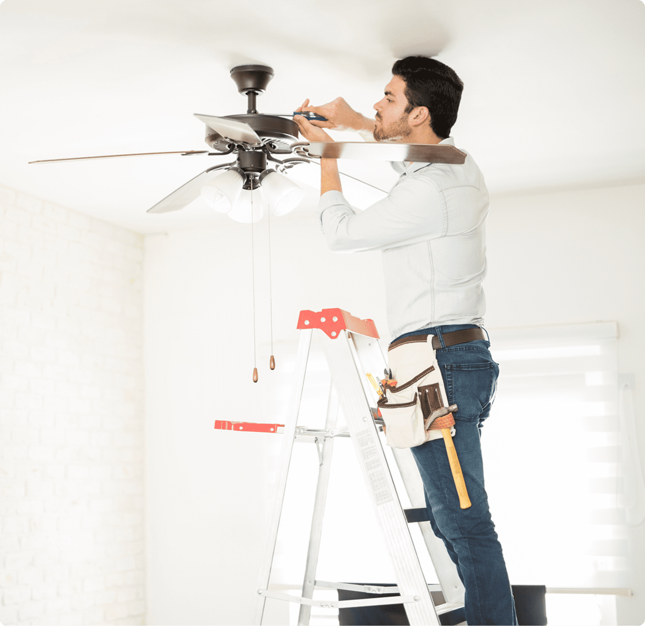Worker adjusting ceiling fan blades