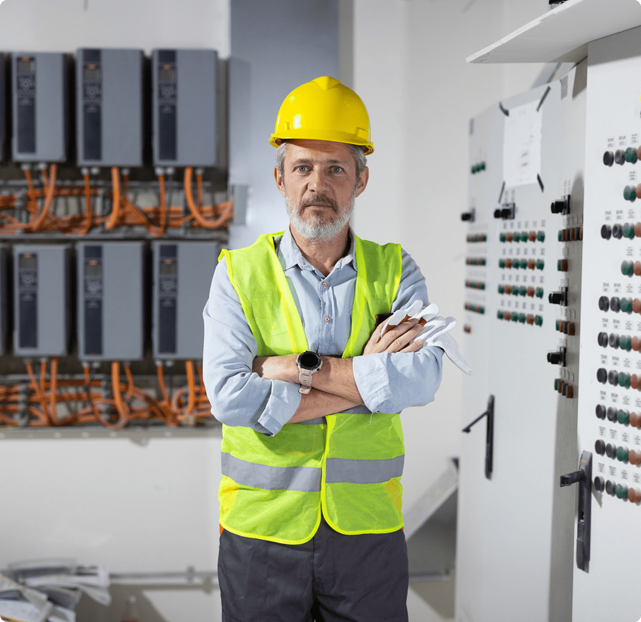 Man in safety gear by control panels
