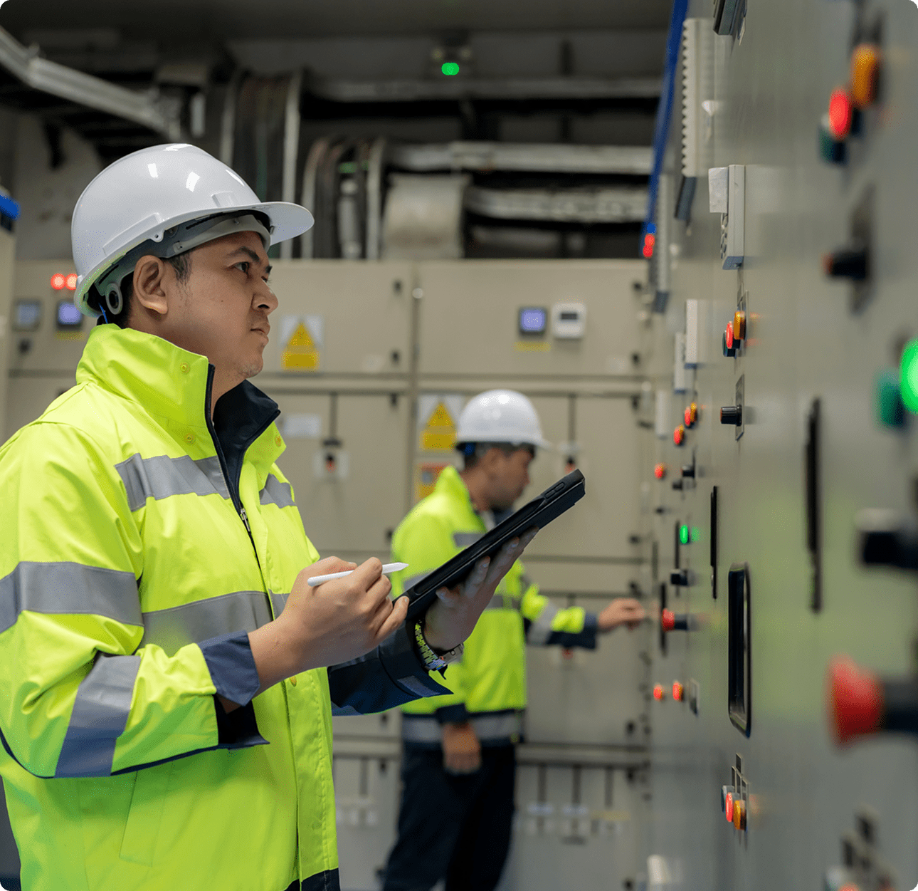 Industrial technicians monitoring electrical systems