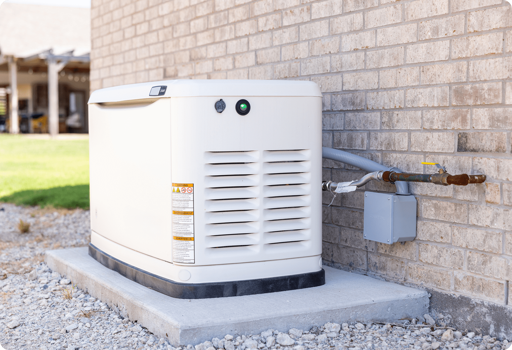 Outdoor backup generator beside brick wall