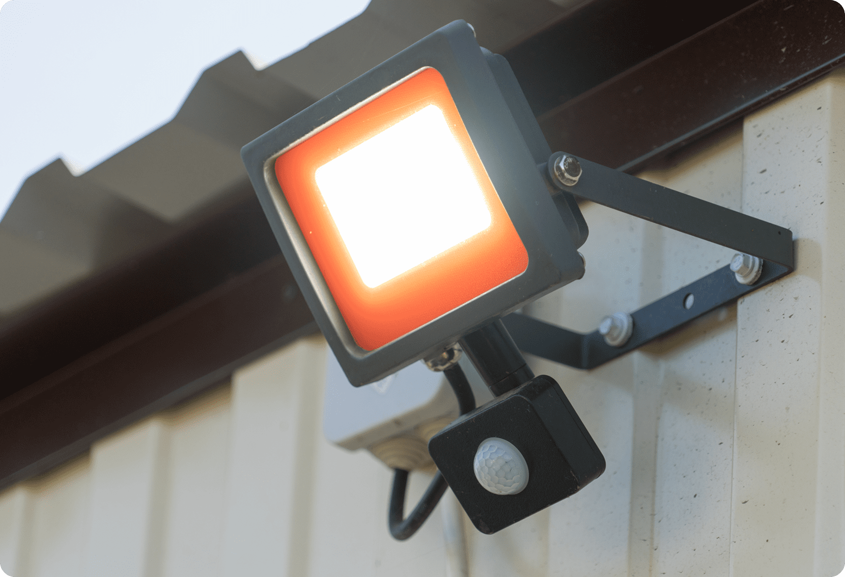 Wall-mounted floodlight with motion sensor.